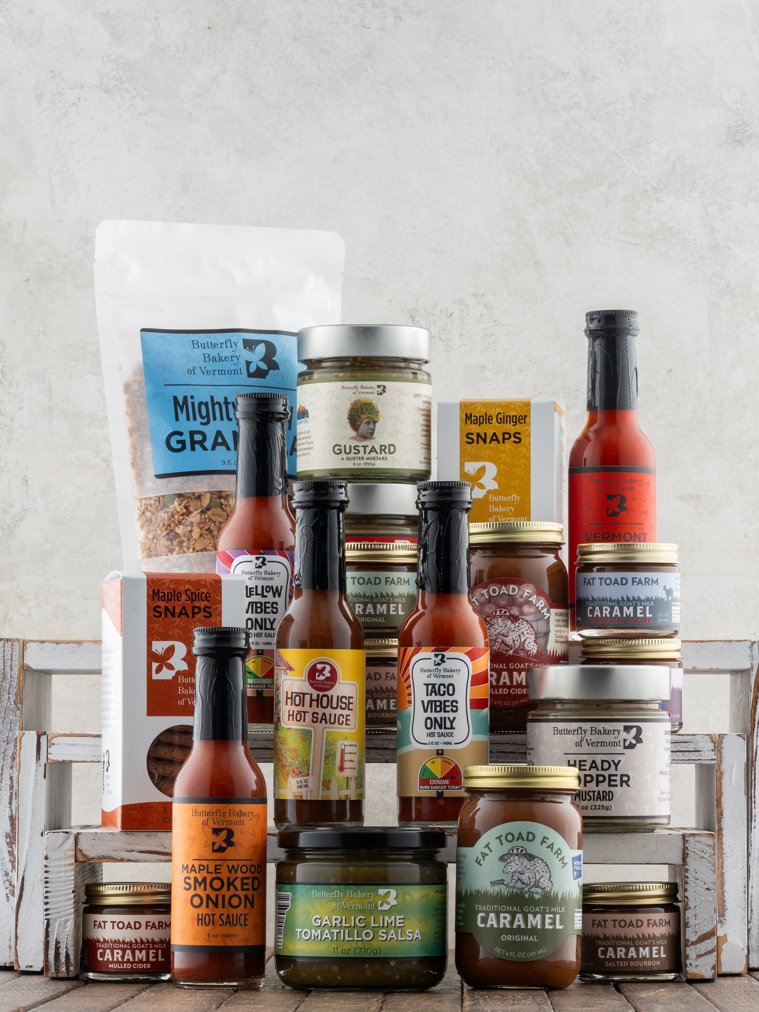 Butterfly Bakery of Vermont and Fat Toad Farm full line of products on a wood surface