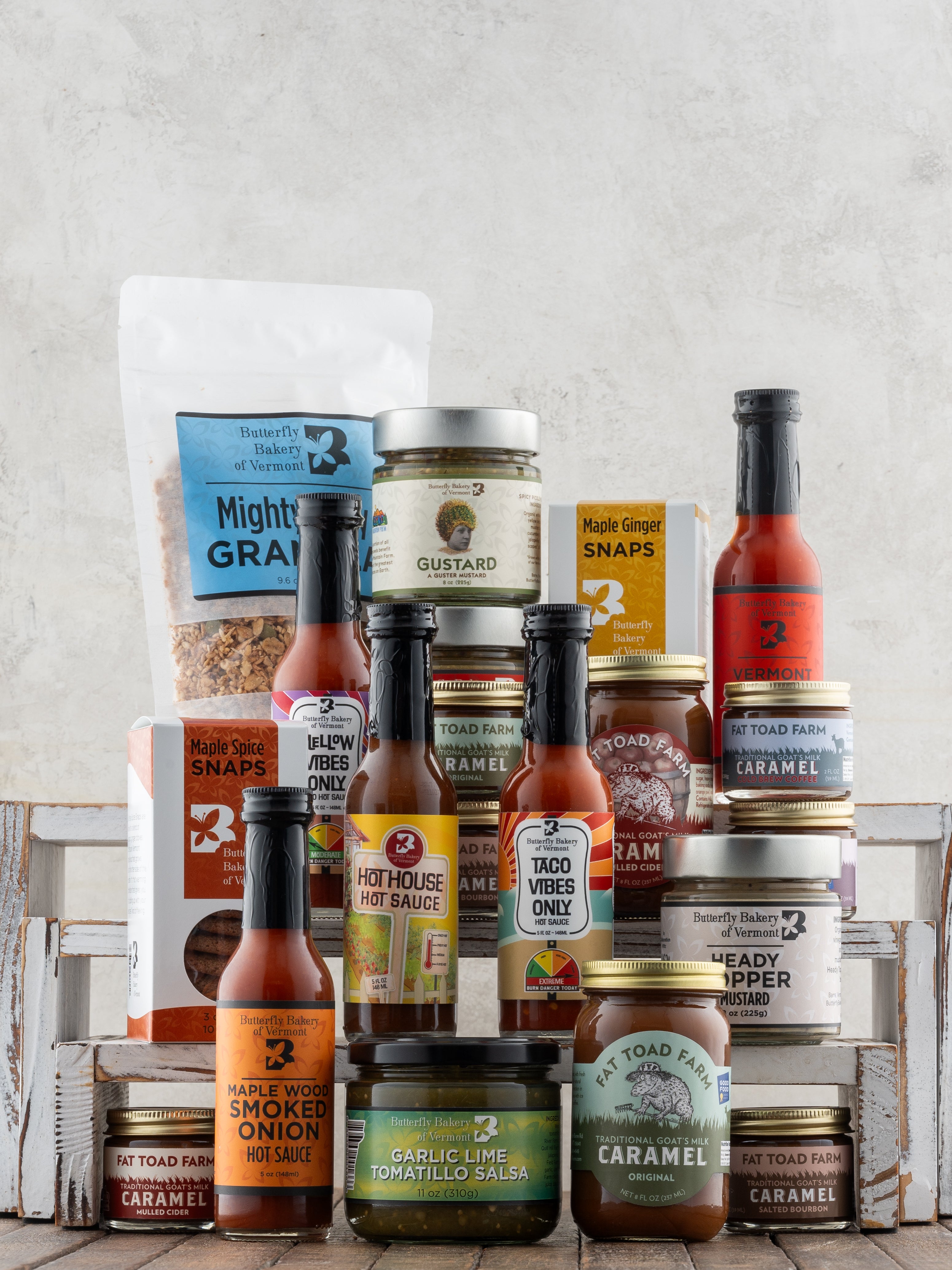 Butterfly Bakery of Vermont and Fat Toad Farm full line of products on a wood surface