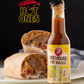 Bottle of Butterfly Bakery of Vermont Hot House hot sauce with a 'As Seen on Hot Ones' badge sitting on a table alongside a burrito cut in half on a plate