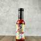 Bottle of Super Hot Odds & Ends hot sauce from Butterfly Bakery of Vermont on a wood table