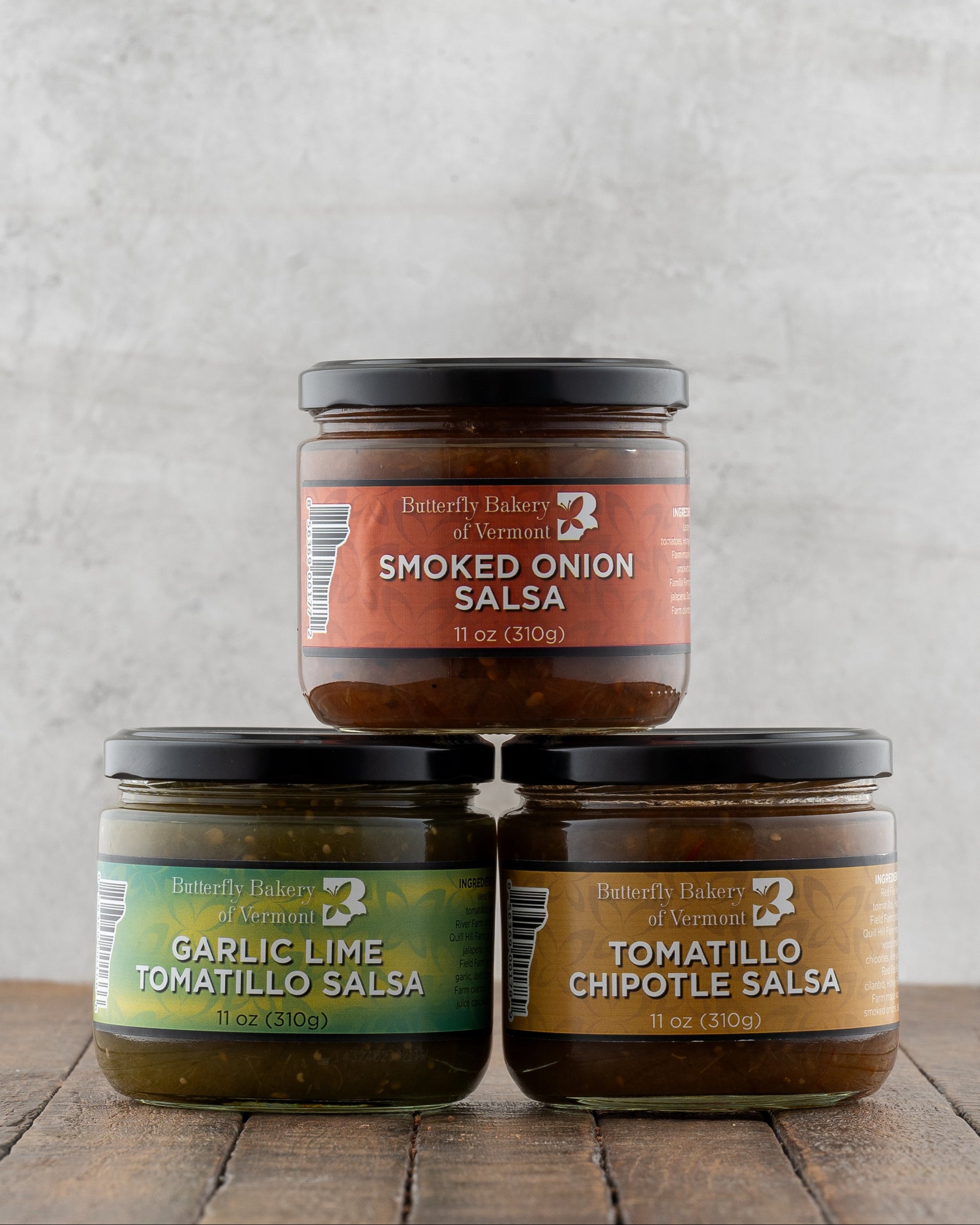 Butterfly Bakery of Vermont full line of Salsa on a wood surface 
