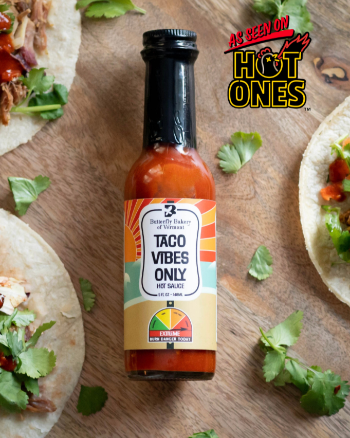 Photo of a bottle of Taco Vibes Only hot sauce from Butterfly Bakery of Vermont with As Seen On Hot Ones logo